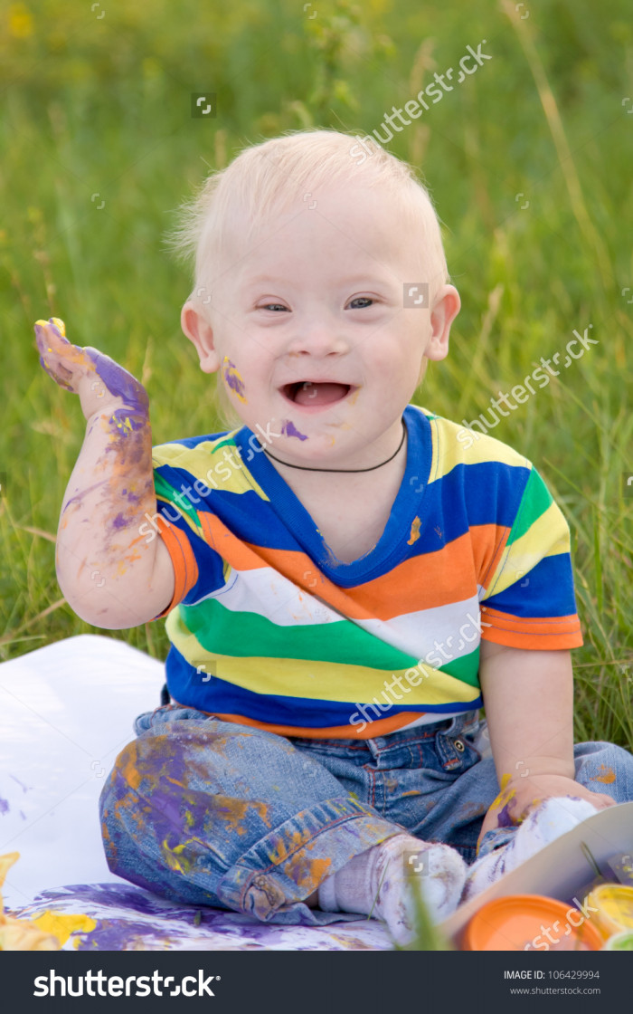 stock-photo-little-baby-boy-with-down-syndrome-painting-finger-paints-on-white-paper-with-a-smile-happiness-is-106429994